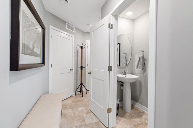 (Photo of a decorated model, actual homes finishes will vary) (Photo of decorated model, actual home's finishes vary) Conveniently located powder bath on the main level. | Image 6