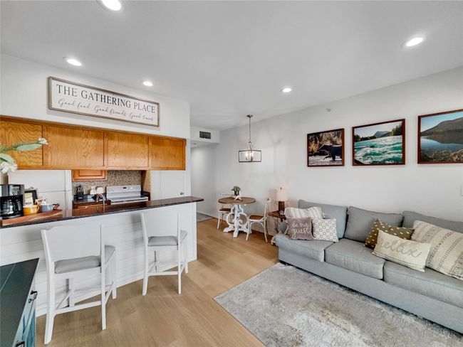 Living area with light wood-type flooring and recessed lighting | Image 8