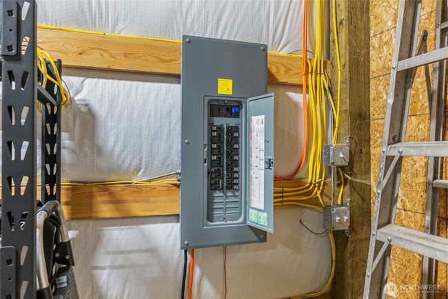 Electrical panel in the garage is 200 amp panel with multiple 30 amp outlets throughout the garage. You can run a welder, chargers, heaters or compressor in this garage. This panel is independant from the house panel. There is a separate panel down at the future home building site. | Image 24