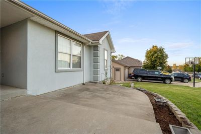 View of side of home featuring a garage and a lawn | Image 3