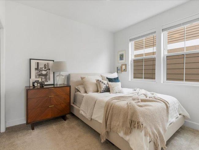 Bedroom featuring light colored carpet and baseboards | Image 7