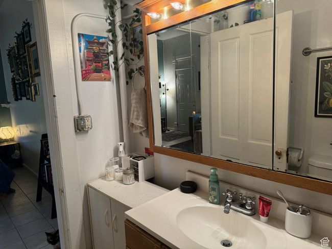 Bathroom featuring tile patterned flooring, vanity, and toilet | Image 19