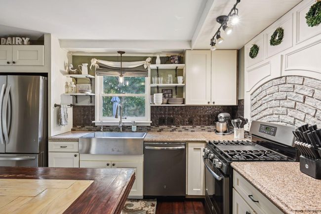 Additional view of the large kitchen offering plenty of work space. | Image 17