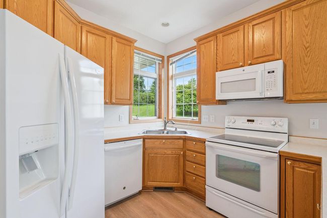 Beautiful kitchen with 42" custom oak cabinets, tons of storage & counter space. Light & bright kitchen window. | Image 15