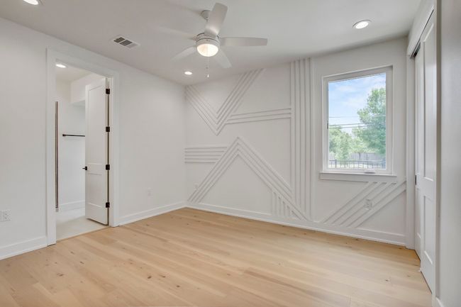 Empty room with light wood-type flooring, a ceiling fan, recessed lighting, and baseboards | Image 17