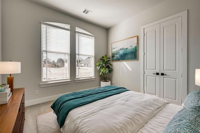 Bedroom featuring visible vents, baseboards, a closet, and light carpet | Image 22