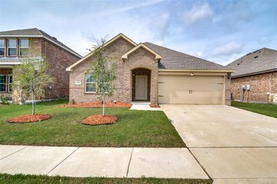 View of front of home featuring a garage and a front lawn | Image 1