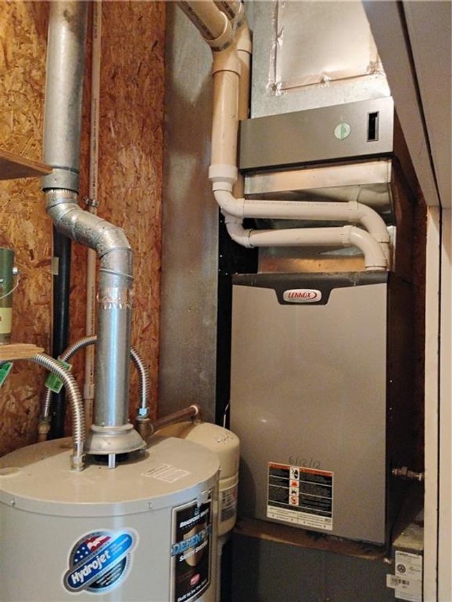 Garage utility room with gas water heater and 90% heater | Image 78