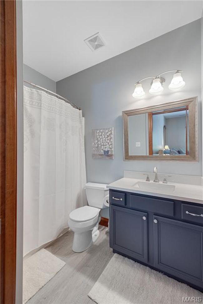 Bathroom featuring wood finished floors, vanity, and a shower with curtain | Image 36
