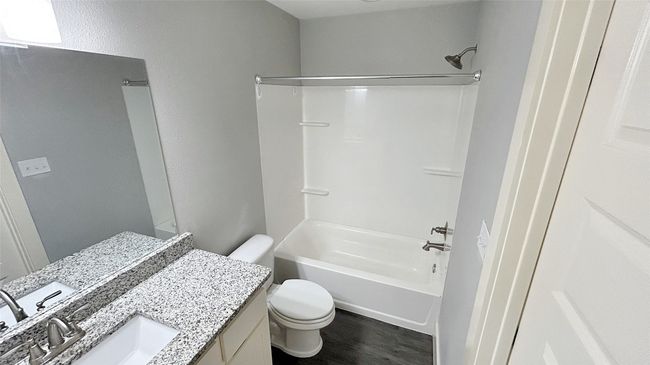 Bathroom with vanity, tub / shower combination, and wood finished floors | Image 12