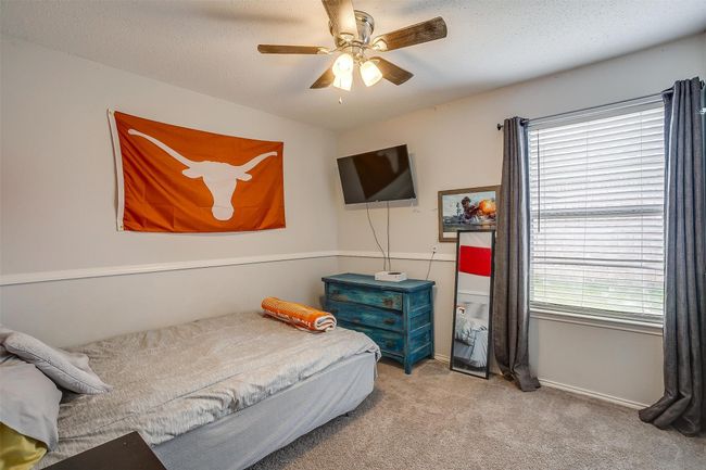 Carpeted bedroom with ceiling fan and baseboards | Image 22