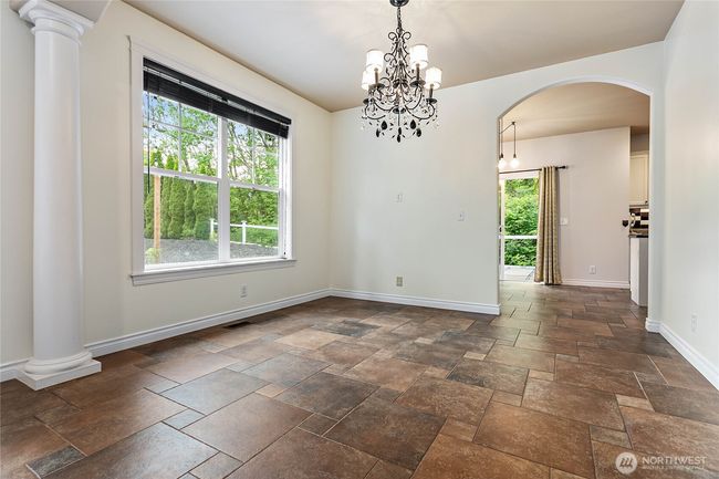 Stepping out of the kitchen, you'll find a formal dining space bathed in natural light. | Image 9