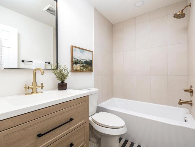 Bathroom featuring visible vents, toilet, vanity, and shower / tub combination | Image 20
