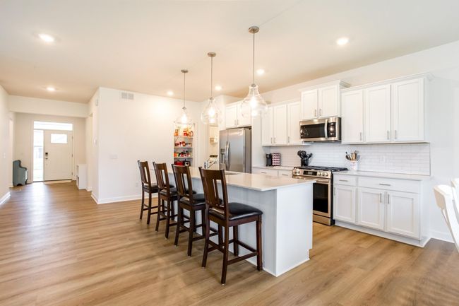 Stylish and seamless flow from the front entry to the heart of the home, with luxury vinyl plank flooring and an open-concept design. | Image 7