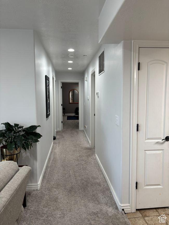 Hallway with baseboards, light carpet, and recessed lighting | Image 13