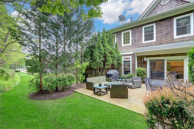 View of grassy yard featuring a patio area and an outdoor living space | Image 25