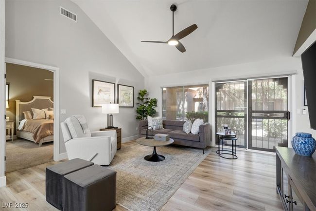 Inside you'll discover soaring majestic ceilings, an open-concept floor plan, sleek pocket windows, & warm natural light. The upgraded interior features luxury flooring, fresh designer paint, & new baseboards. Relax by the linear fireplace or entertain in the formal dining area. | Image 19