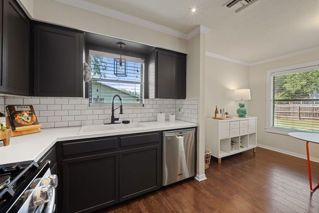 Freshly painted kitchen cabinetry with a chic color invites you into this adorably updated kitchen! | Image 14
