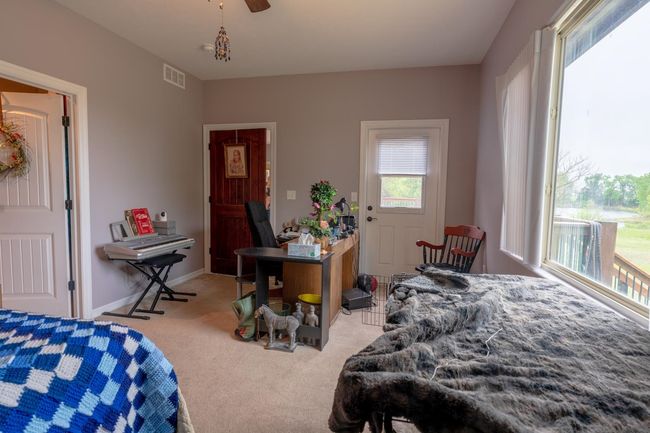 Bedroom featuring visible vents, baseboards, carpet floors, and ceiling fan | Image 15