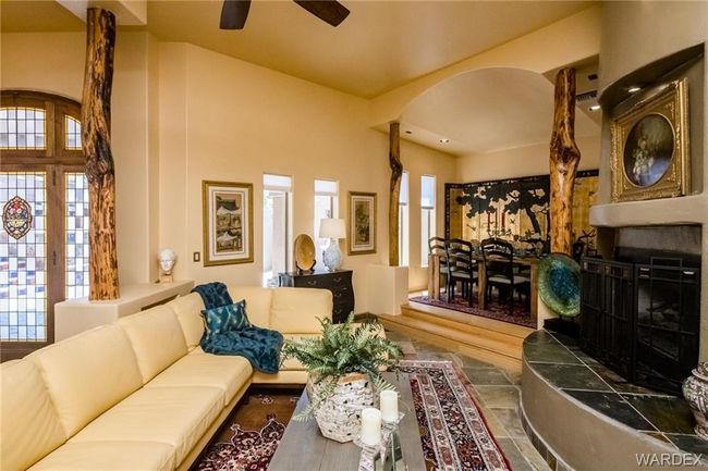 Living room featuring arched walkways, a ceiling fan, and a wall mounted AC | Image 47