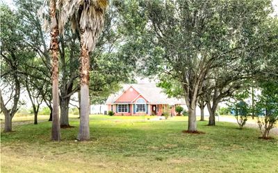 Front view surrounded by cluster of trees | Image 1