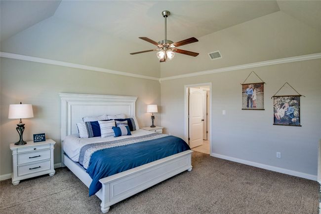 Master Bedroom with ceiling fan, high vaulted ceiling, light colored carpet and baseboards | Image 18