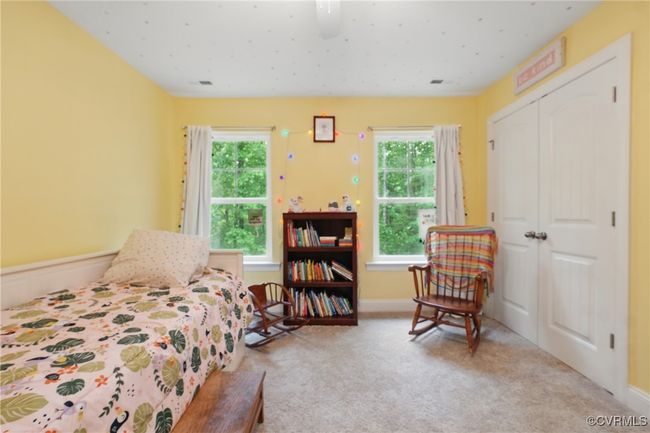 Upstairs bedroom with large windows, soft carpet, and wooded views. | Image 26