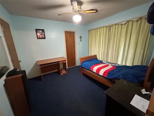 Bedroom with ceiling fan, a textured ceiling, and carpet flooring | Image 20