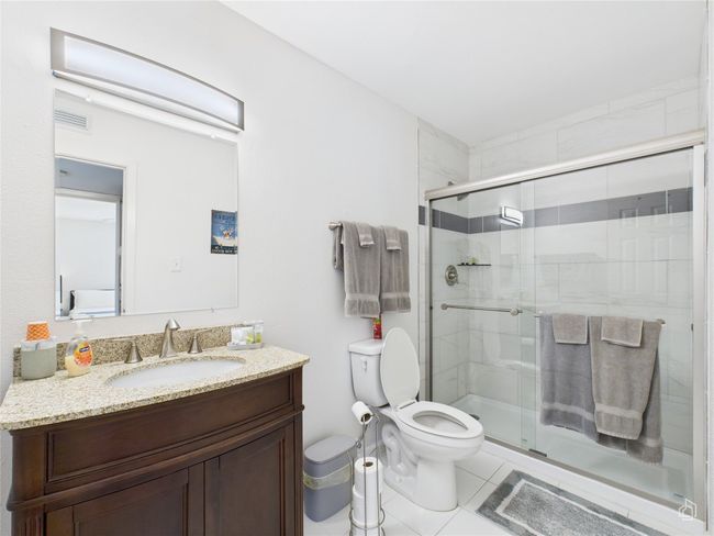 Primary bathroom with beautiful walking shower and granite counter top. | Image 15