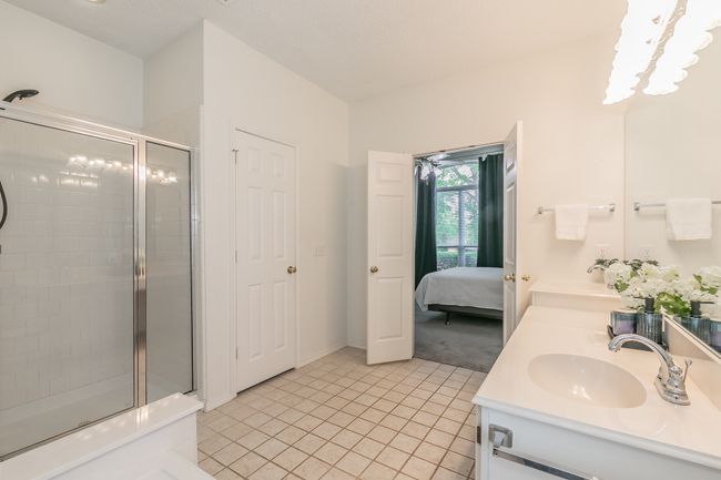 Ensuite bathroom with a sink, double vanity, tile patterned flooring, a shower stall, and ensuite bath | Image 33