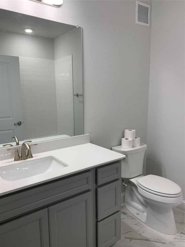 Bathroom featuring vanity and marble look tiles | Image 4