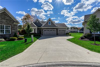 Craftsman inspired home with a garage and a front lawn | Image 1