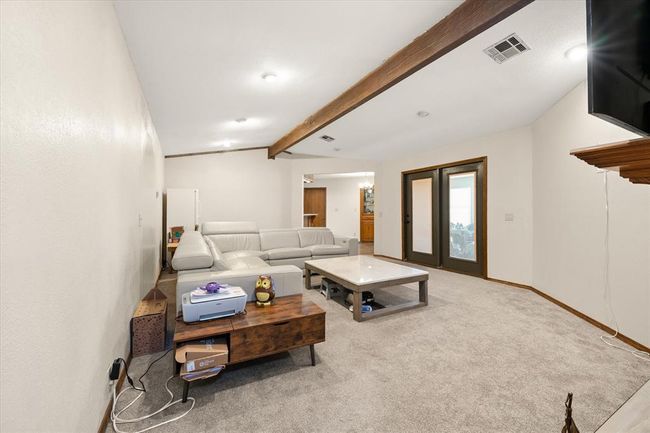 Carpeted living room featuring baseboards | Image 16