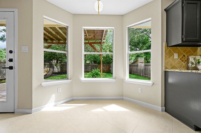 Unfurnished dining area with baseboards and tile patterned flooring | Image 9