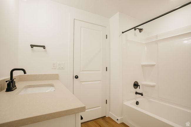 Bathroom with shower / washtub combination, wood finished floors, and vanity | Image 43