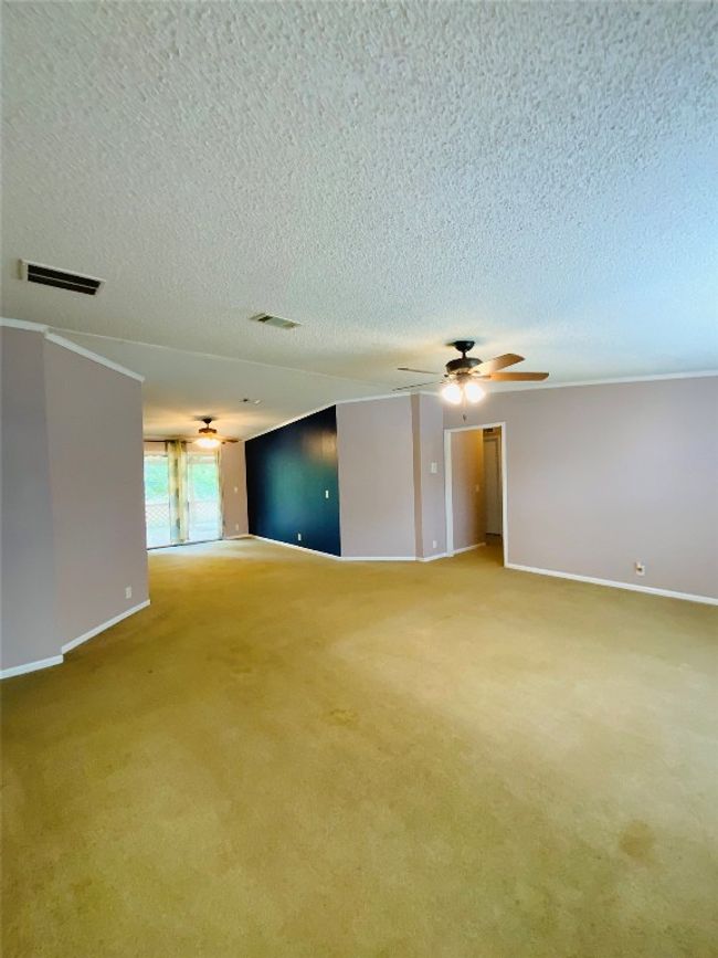 Empty room with baseboards, visible vents, a textured ceiling, and light colored carpet | Image 14