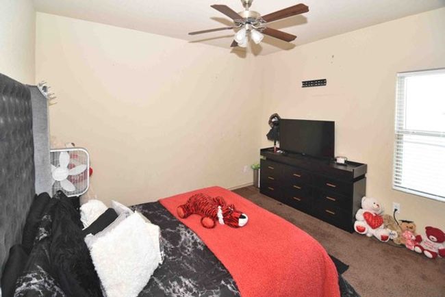 Bedroom featuring dark carpet and ceiling fan | Image 29