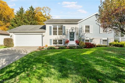 Bi-level home with a front yard and a garage | Image 1