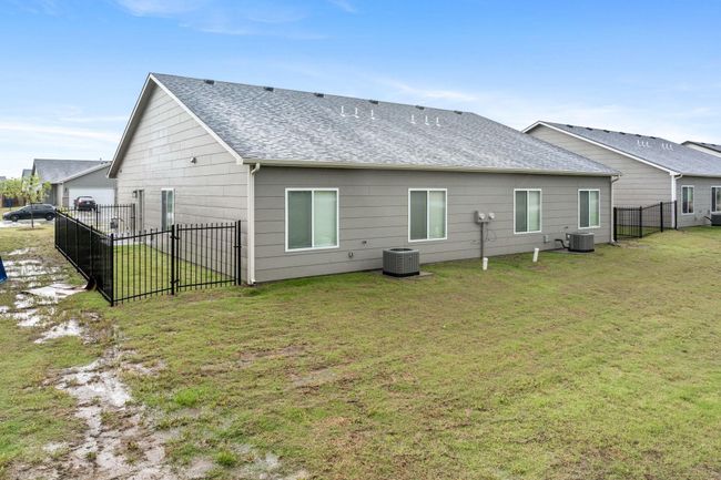 Back of property featuring central air condition unit and roof with shingles | Image 27