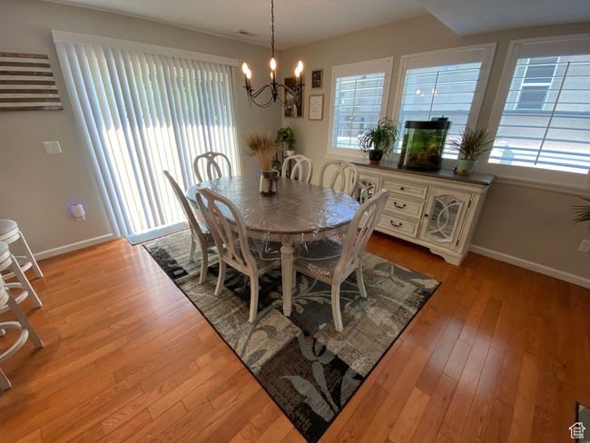 Dining room with a chandelier, baseboards, and light wood-type flooring | Image 5