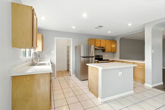 Another view of kitchen taken from dining area. | Image 7