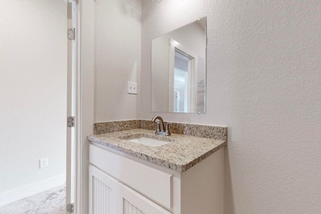 Bathroom featuring vanity and a textured wall | Image 21