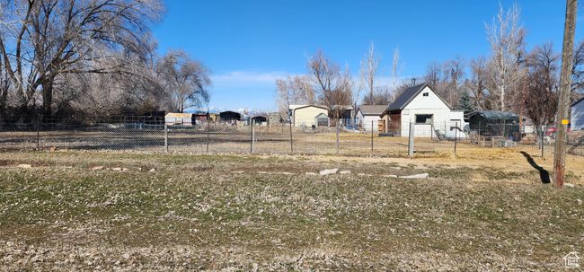 View of partially fenced pasture and barn | Image 25