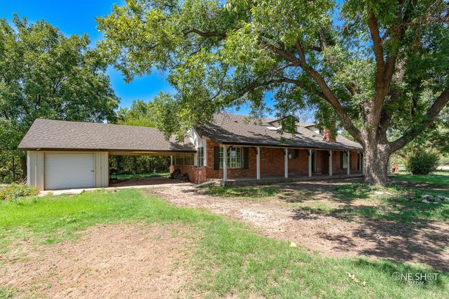 Ranch-style house featuring a carport | Image 32