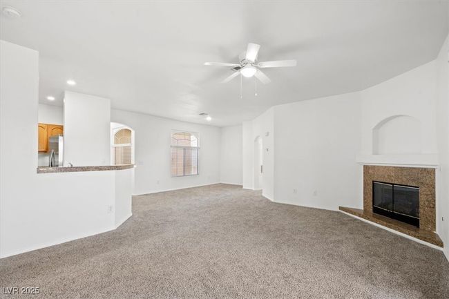 Unfurnished living room with recessed lighting, a premium fireplace, a ceiling fan, and carpet flooring | Image 9