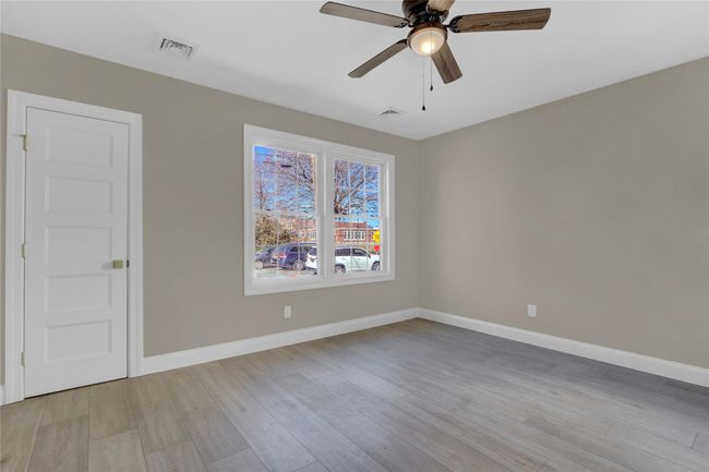 Empty room featuring a ceiling fan, light wood-type flooring, visible vents, and baseboards | Image 9