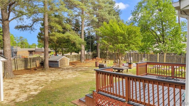 View of yard featuring an outbuilding, a shed, a deck, and a fenced backyard | Image 28