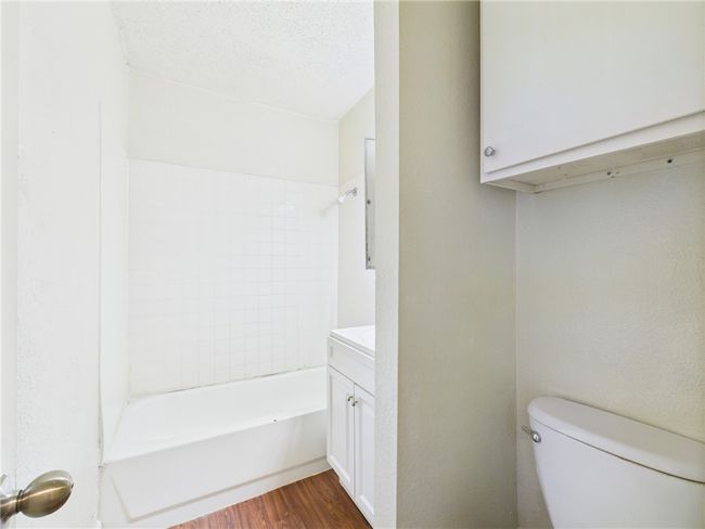 Full bath featuring wood finished floors and vanity | Image 15
