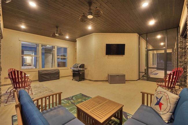 This generously sized patio easily accommodates multiple seating areas, making it perfect for relaxing, entertaining, or enjoying sports games in comfort. | Image 37