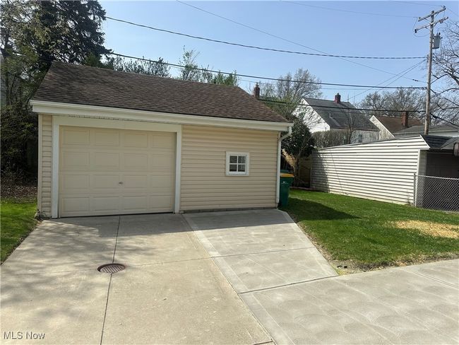 Detached garage featuring driveway and fence | Image 8